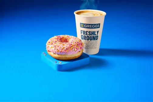 Greggs Now Open 7 Greggs doughnut with a hot drink